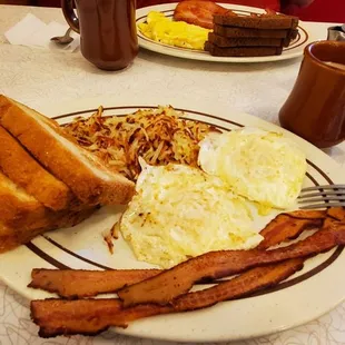 Farmers breakfast, 2 over medium, bacon, hashbrowns, Texas toast. Yummy