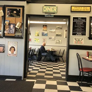 a man sitting at a table in a diner