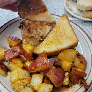 Tenderloin sandwich on toast, home fries.