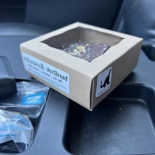 a box of food in the passenger seat of a car