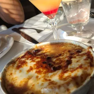 a bowl of soup and a cocktail