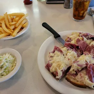 Open faced Reuben with fries and slaw.