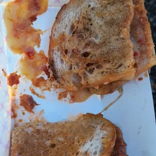 a half eaten grilled cheese sandwich