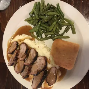 Today's special-pork tenderloin with molasses gravy, whipped potatoes, sautéed green beans, roll