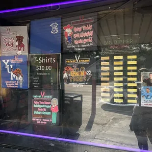 a storefront window with various signs