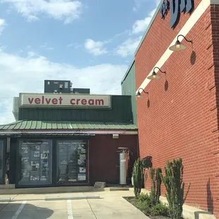a brick building with a sign that says velvet cream