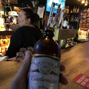 a person holding a bottle of beer