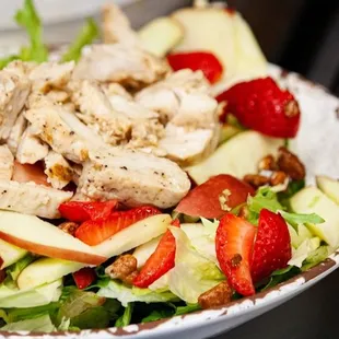 a chicken salad with strawberries and apples