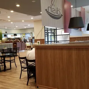 a dining area with tables and chairs