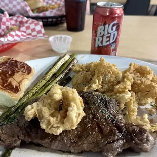 Ribeye with roll, asparagus and onion rings - so flavorful! All cooked to perfection.