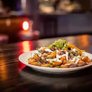 Carne Asada Fries with Nacho Cheese, Pico De Gallo, Guacamole, Sour Cream, Jalapeños