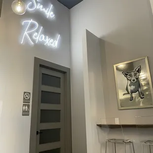 a bar with a neon sign above it