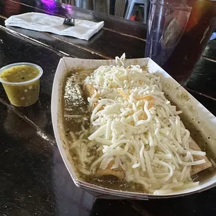 Papa taquitos with green sauce and cheese