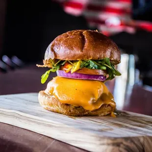 a cheeseburger on a wooden board