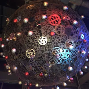 a large metal sphere with gears and gears on it