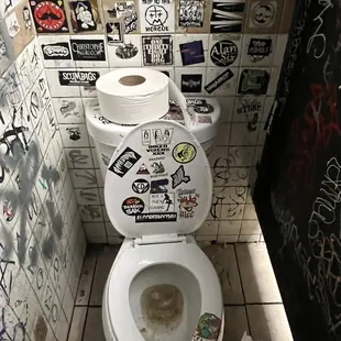 a toilet covered in stickers
