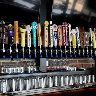 a row of beer taps on a bar