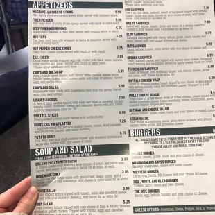 a person holding up a menu