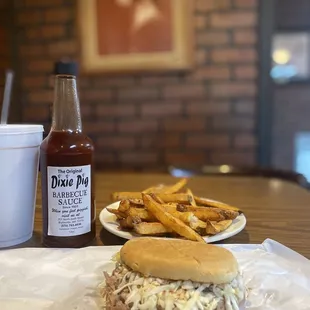 a pulled pork sandwich and french fries