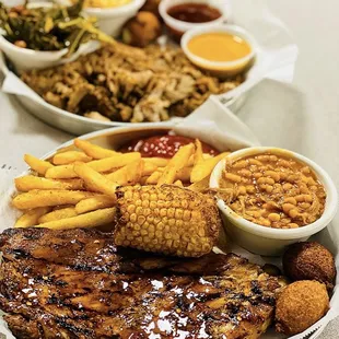 Half rack of ribs with a pulled pork dinner behind