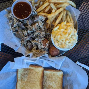 Pulled Pork with house Bbq, Mac n cheese, hush puppies and fries $13 + side of Texas toast 0.75