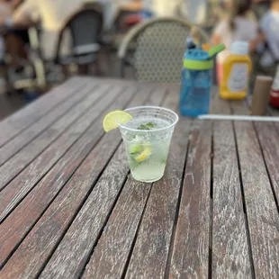 a glass of lemonade on a wooden table