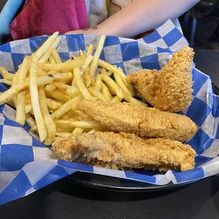 a basket of fried fish and fries