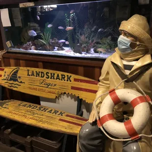 a statue of a man with a mask and a life preserver