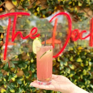 a hand holding a drink