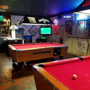 two pool tables and a television