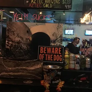 a bar with a sign that says beware of the dog