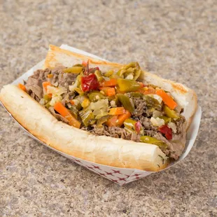 a beef sandwich with peppers and onions