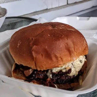 Burger with bacon, bleu cheese, and grilled onions.
