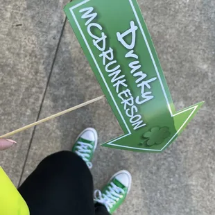 a person holding a green sign