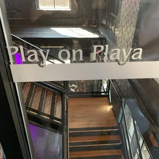 a view of a stairway leading to a play on play sign