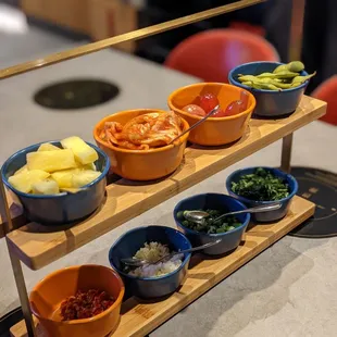 Each table gets a toppings/sides ensemble.