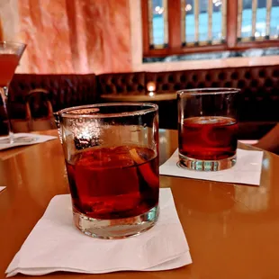 two glasses of alcohol on a table