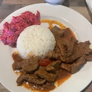 Carne guisada with white rice, beans, and ensalada rusa