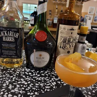 a glass of alcohol and a bottle of liquor