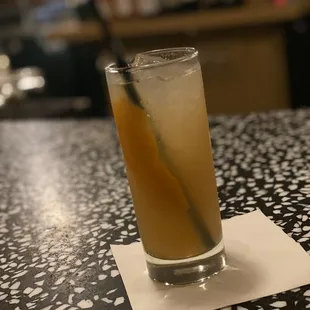 a glass of orange juice on a table