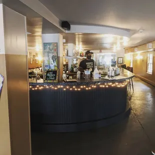 a man standing at a counter in a restaurant
