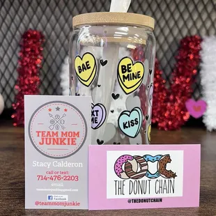 a jar of donuts and a business card