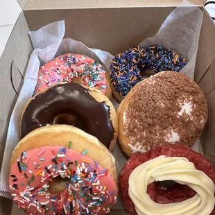 Strawberry, chocolate frosted, chocolate with sprinkles, blueberry filled, and red velvet with cream cheese frosting