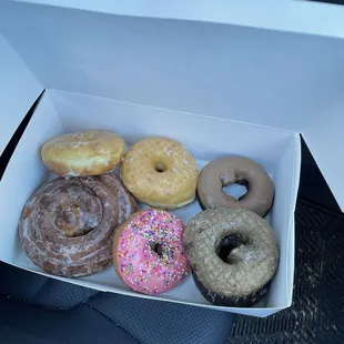 Cinnamon roll, 2 glazed donuts, strawberry sprinkle donut, maple donut and 2 cake donuts