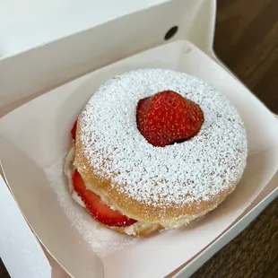 a strawberry and powdered sugar donut