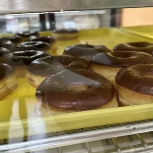 a variety of donuts in a display case