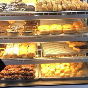 a variety of donuts in a display case