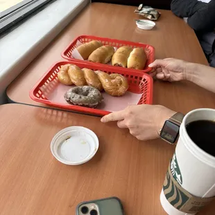 a tray of donuts and a cup of coffee