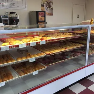 a variety of donuts in a display case