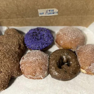 L-R: Apple Bear Claw, Ube Donut , Nutella Donut, Purple Birthday Cake Donut, Blueberry Cake Donut